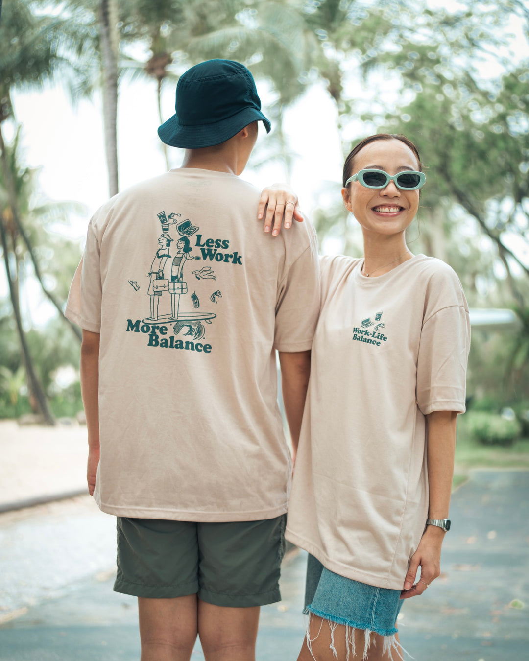 lady facing the front and man facing the back standing side by side in a graphic t shirt