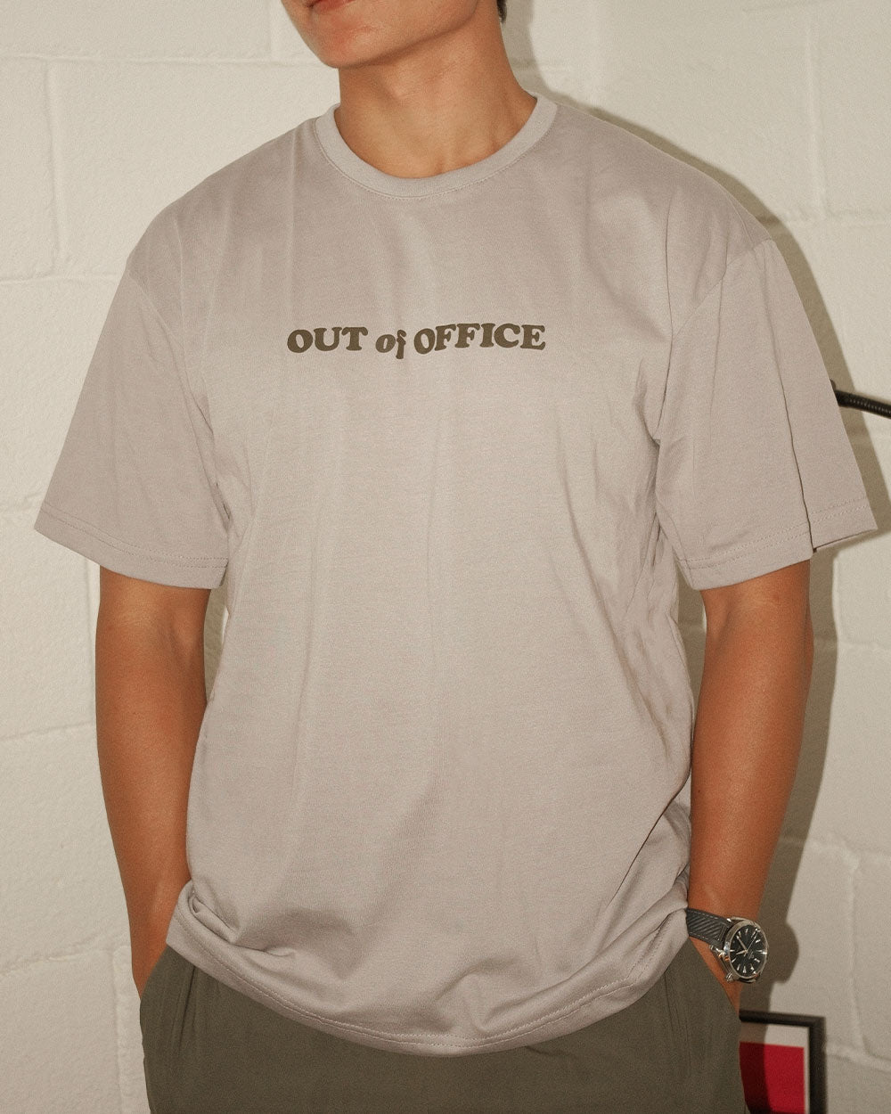 man in a grey t shirt that says out of office